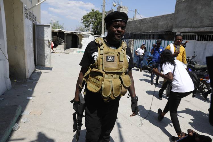 Jimmy Chérizier, a former elite police officer known as Barbecue who leads the G9 and Family gang, walks away after speaking to journalists in the Delmas 6 neighborhood of Port-au-Prince, Haiti, Monday, March 11, 2024. (AP Photo/Odelyn Joseph)