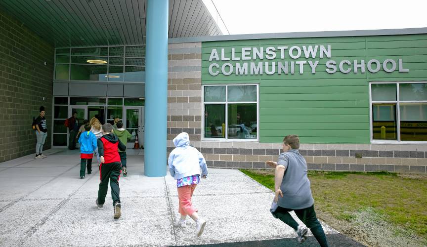Allenstown students enter the new school on Thursday morning, April 18. A group of students came to the school to get a greeting and a tour of the new facility. 