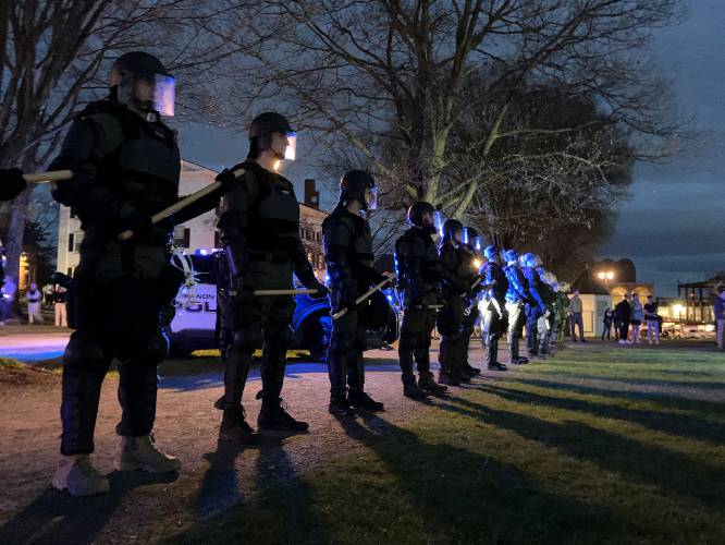 Police from area departments gather on the Dartmouth Green on Wednesday evening, May 1, 2024, in Hanover, N.H., as others protest the ongoing war in Gaza and also the arrest of two Dartmouth student protesters last fall. (Valley News - James M. Patterson) Copyright Valley News. May not be reprinted or used online without permission. Send requests to permission@vnews.com.