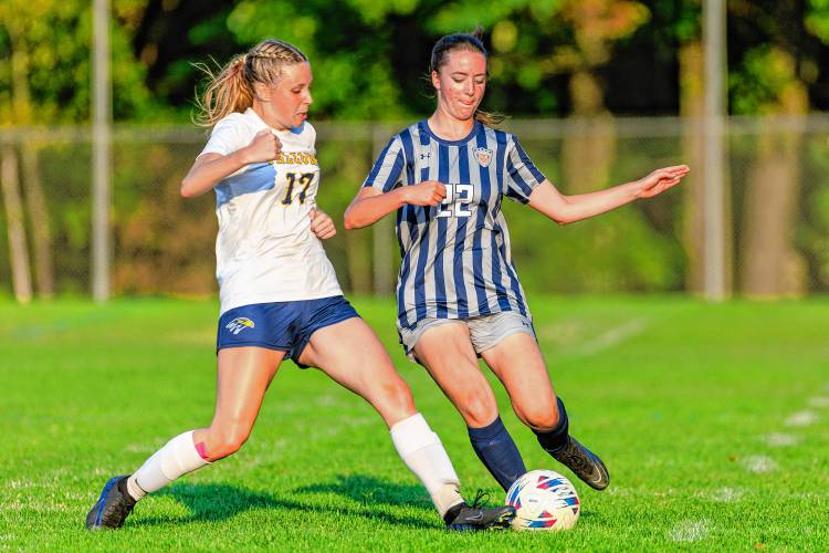 Bow’s Lexana Farr (left) and Merrimack Valley's Ellie Andrews (22) fight for possession during a game at MV on Thursday.
