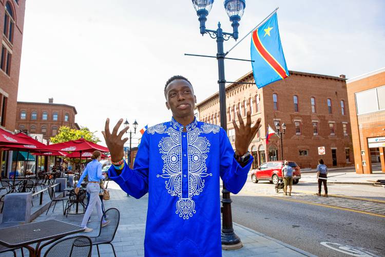 Fisto Ndayishimiye on Main Street in Concord where the sidewalks are adorned with international flags for this coming Sundayâs Multicultural Festival at Keach Park.
