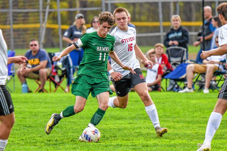 Hopkinton’s Fin Murphy (11) controls the ball during the Hawks’ homecoming match against Stevens. Hopkinton won, 3-1, on Saturday.