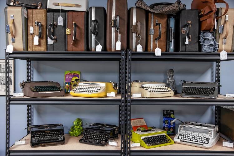 Matt Snyder opened New England Typewriter to sell and service devices that are decades old. On the shelves of the store Snyder displays old typewriters including manual and electric typewriters, along with their cases.