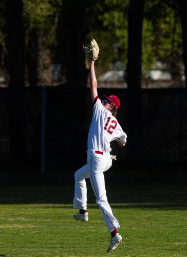At right, Concord right fielder Michael Barry leaps for a ball against Windham in the sixth inning.