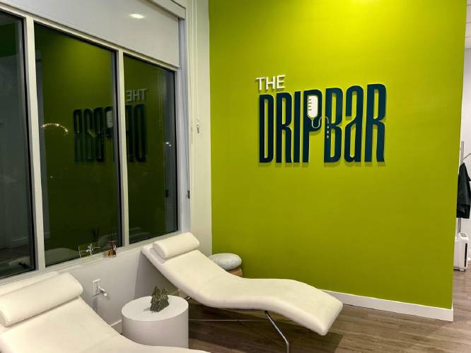 Patients at the Drip Bar sit in one of the seven white leather lounge chairs that line the main room.