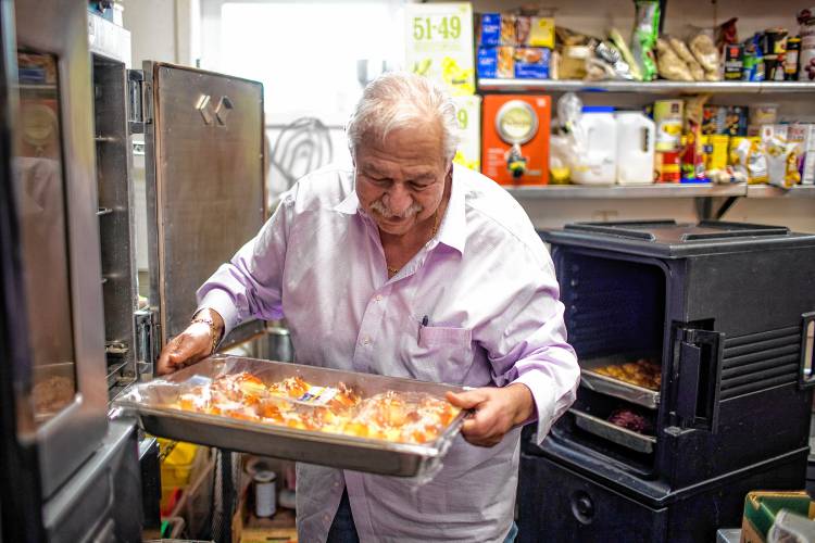 Alan Andrian takes out manicotti that goes out to the Hospice House to feed not only patients but their familites and staff at the Alanâs of Boscawen kitchen on Friday, January 19, 2024.