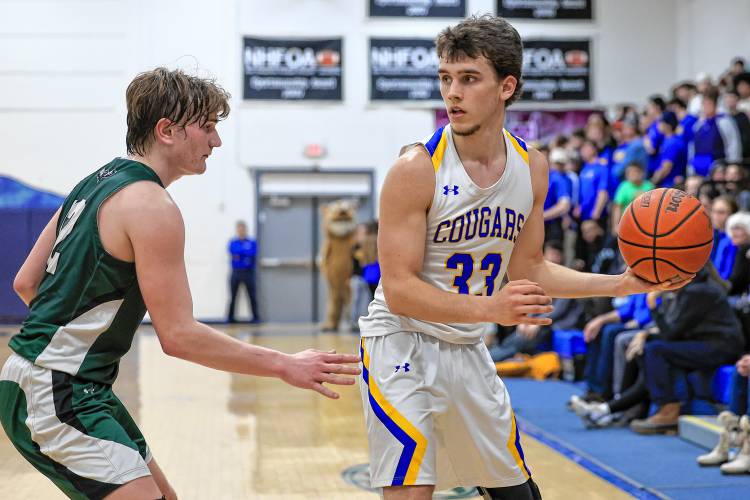 Kearsarge junior Noah Whipple looks to make a pass as Hopkinton’s Colby Boissy defends him on Friday night.