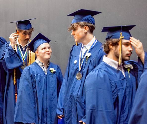 Brothers Shannon McGrade, middle left, and brother, Ryan, middle right, line up to process into the stage of the Sullivan Arena at St. Anselm College, ready to graduate with the Bow High School class of 2024.