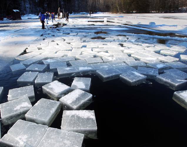 Blocks of ice float in the former Squaw Cove, now known as Eastman Cove, on Thursday Jan. 9, 2014 in Sandwich, N.H. ready to be harvested and put into the ice house at Rockywold-Deephaven Camp. For more than a century ice has been taken from Squam Lake and put in an ice house to be used by summer residents at the camp. More than 3,500 blocks of ice will be stored and stay frozen till summer. (AP Photo/Jim Cole)