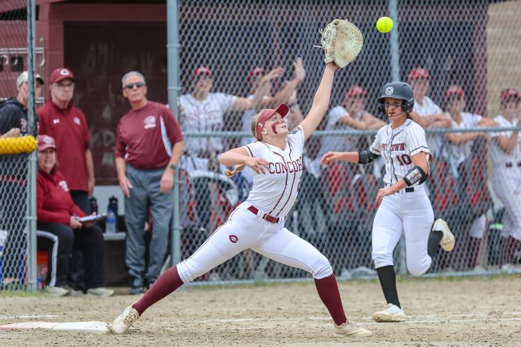 Tess Bolduc reaches for an out at first base in Concord's Division I softball quarterfinal victory on Monday at Goffstown High School. No. 12 Concord upset No. 4 Goffstown, 7-1, to reach the final four for the 15th time in the last 20 seasons.