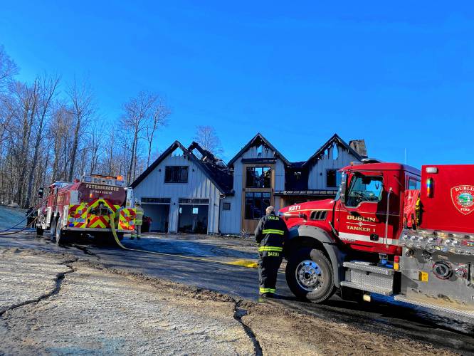 Firefighters review the damage at a Cranberry Meadow Drive home Tuesday morning. 
