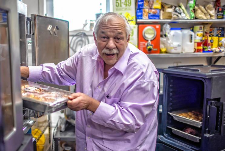  Alan Andrian takes out manicotti that goes out to the Hospice House to feed not only patients but their families and staff at the Alan’s of Boscawen kitchen on Friday.