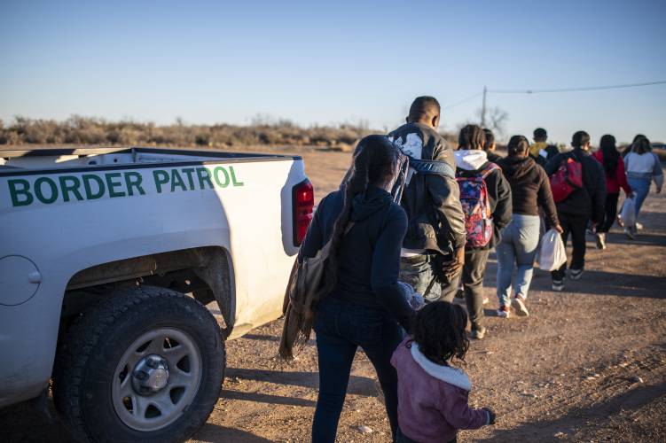 A group of migrants are processed by Border Patrol after crossing the U.S.-Mexico border on Feb. 4 outside Eagle Pass, Texas.