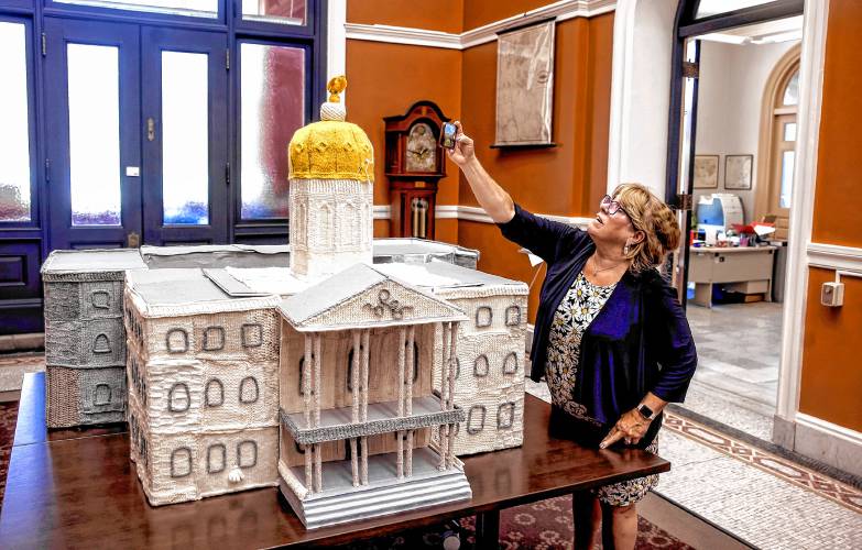 Virginia Drew of Epsom takes a photo of the Knit Democracy Together State House knitting model at the New Hampshire State Library on Thursday, June 13, 2024. The project was part of a intitiative from New Hampshire Humanities and the National Endowment for the Humanities.