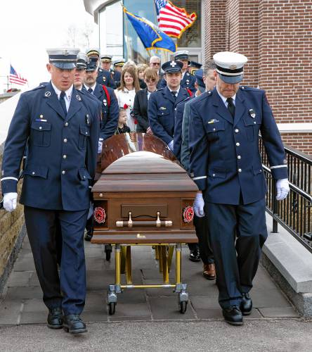 Shannon Girard follows as fellow firefighters carry the casket after the funeral service for Concord firefighter CJ Girard at Christ the King Catholic Church on Thursday.