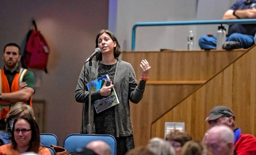 Shanon Bader speaks at the Bow School District meeting on Friday night, saying that the support aides at Bow Elementary School deserve more pay because of the great work they do for her son.