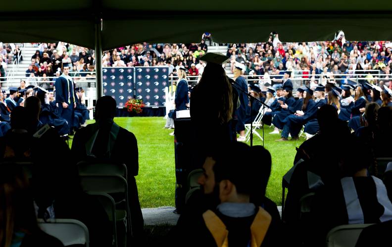 Merrimack Valley graduate Lenna Quiter reads off the accomplishments of the student body at the Saturday graduation on the athletic field.