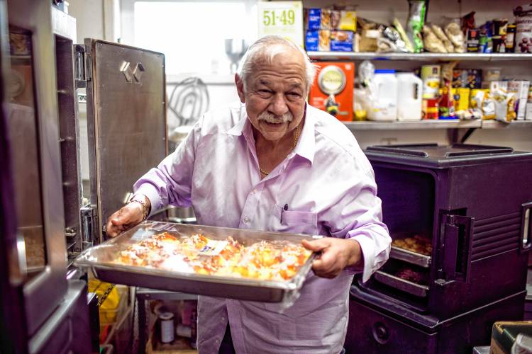 Alan Andrian takes out manicotti that goes out to the Hospice House to feed not only patients but their families and staff at the Alan’s of Boscawen kitchen on Friday.