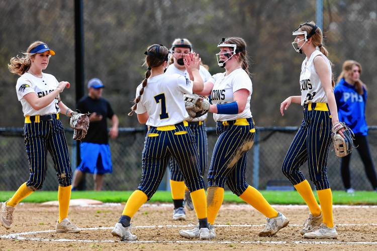 Taylor Ouellette (second from right) high fives Maddy Oppold (7) during Friday’s 9-0 win over Pelham.