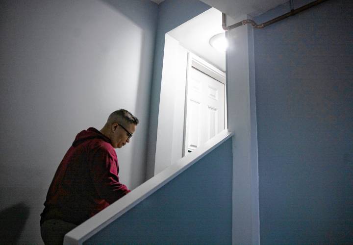 Glenda Leon, director of emergency housing at the Friends Program, walks up the new staircase during a tour of the remodel of the Thompson Street facility for families on Wednesday, May 8, 2024. 