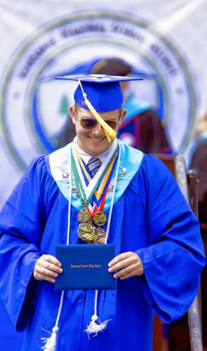Kearsarge Regional High School graduate Thomas Shepard smiles after receiving his high school diploma at the school on Saturday, June 8, 2024.