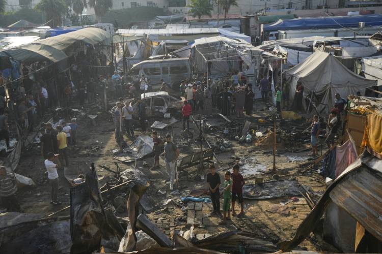 Palestinians look at the damage after an Israeli strike hit a tent area in the courtyard of Al Aqsa Martyrs hospital in Deir al Balah, Gaza Strip, Monday, Oct. 14. Palestinians look at the damage after an Israeli strike hit a tent area in the courtyard of Al Aqsa Martyrs hospital in Deir al Balah, Gaza Strip, Monday, Oct. 14.