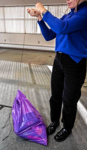 The purple trash bag did not hold up on the 40-pound test when it was held by just the string; it ripped and fell to the floor.