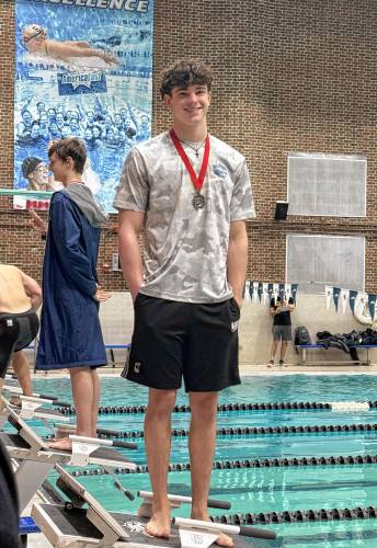 Belmont’s Kyle Dumais celebrates with his medal after finishing second in the 100-yard freestyle at Friday’s state meet. Dumais also won the state title in the 50 free.