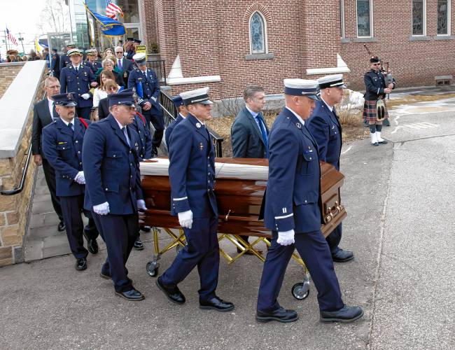 Fellow firefighters carry the casket after the funeral service for Concord firefighter CJ Girard at Christ the King Catholic Church on Thursday, March 13, 2025.