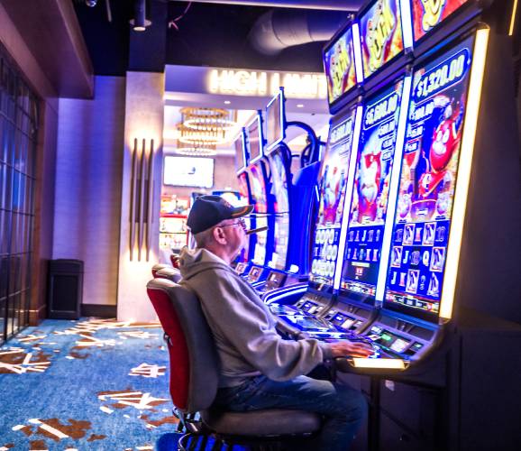 Paul Bergeron of Lowell, Mass., plays a video casino game at The Nash Casino in Nashua on Wednesday. Part of the casino parking lot is in Massachusetts.