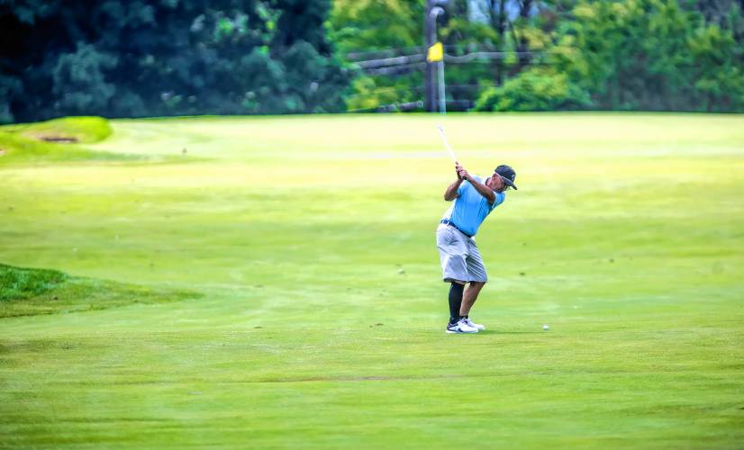 Concord’s own Bob Mielcarz hits his approach shot on the first hole at Concord Country Club on what could be his last round at the State Am tournament on Tuesday, July 9, 2024.