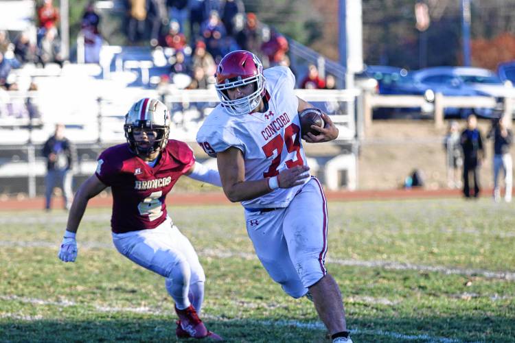 Concord's Wayne Sakakeeny (79) runs with the ball for a big gain after taking a lateral pass from a teammate during the Crimson Tide's Division I preliminary round game on Saturday in Hudson. Concord lost to Alvirne, 33-10, for an early playoff exit.