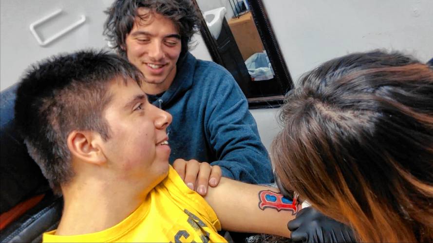 Samuel Habib (left) getting a Red Sox tattoo and being supported by his brother, Isaiah Habib. Credit: Dan Habib/LikeRightNow Films