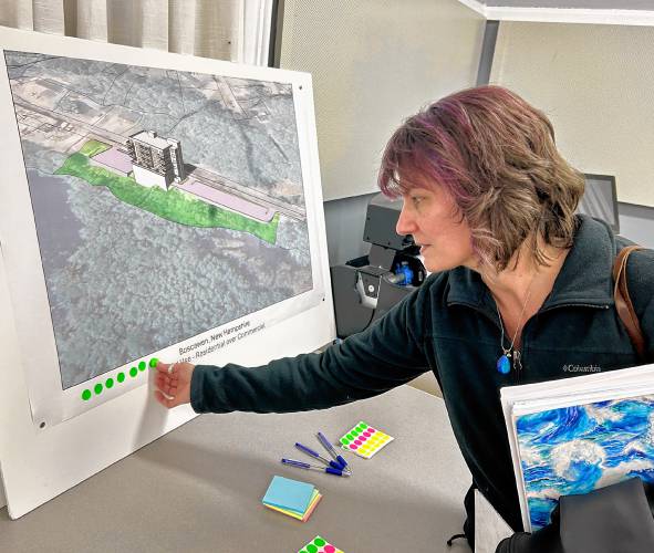 Boscawen resident Loren Martin votes for her favorite option during a visioning session Thursday night about the town's future Commercial Street development.