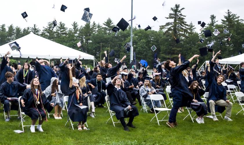 Merrimack Valley graduates throw up their caps at the conclusion of the ceremony on Saturday.