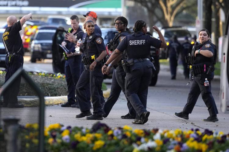 Harris County Sheriffs officers walk outside of Lakewood Church after a reported shooting during a church service in Houston, Sunday, Feb. 11, 2024. (Karen Warren/Houston Chronicle via AP)