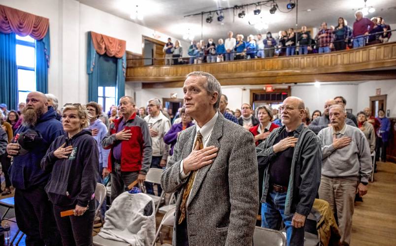 Newly-elected assistant town moderator Ben Frost (center) leads Warner residents in the Pledge of Allegiance at the beginning of the Warner Town Meeting on Wednesday. Frost will be taking over as moderator next year as long-time moderator Ray Martin will retire after the meeting.