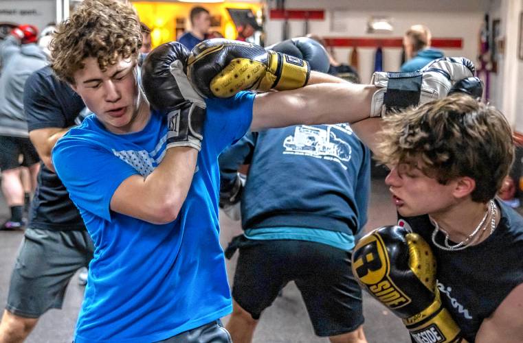 Ritchie Philbrick practices fending off his brother Ronnie’s punches during their boxing class at Averill’s  in downtown Concord. They never land an actual punch during the class.