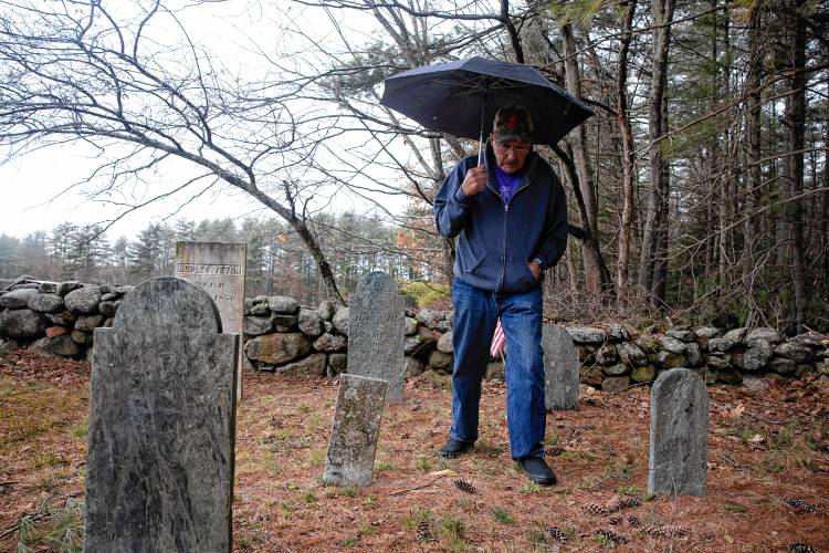 Norm Yeaton looks over the grave markers in the private Yeaton cemetery off of Black Hill Road in Epsom on Thursday, April 11, 2024. Yeaton has taken on the arduous research project by Yeaton to understand the sheer volume of people in Epsom whose last name was the same as his--even when the name was Yeton before they added the ‘a’ early in the 19th century.