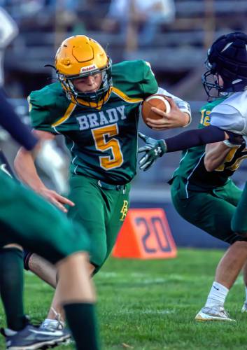 Bishop Brady quarterback Joey Richardson (5) runs through the line on his way to a touchdown against Newfound at Memorial Field in Concord on Saturday evening. Richardson ran for 141 yards and scored three touchdowns on the ground, while also throwing a TD pass.