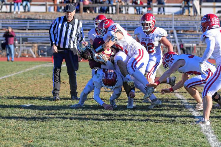 Concord’s Jax Diachenko (52) tackles an Alvirne runner during Saturday’s playoff game in Hudson4. No. 8 Alvirne defeated No. 9 Concord, 33-10, in the Division I prelims.