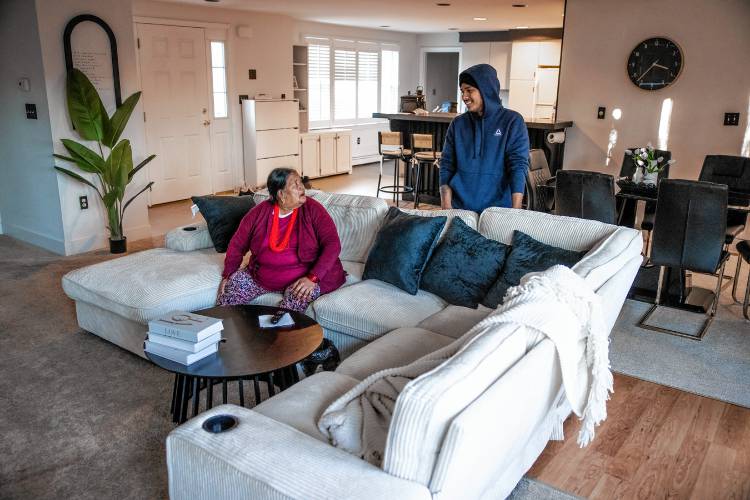 Shamir Darjee (right)) and his grandmother, Aiti Darjee in the living area of his home on Noyes Street in Concord. Darjee recently bought the house and lives there with his family.