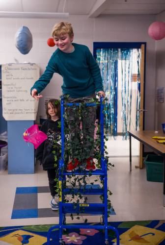 Penacook Elementary School student Petar Devone, 10, tosses a parachute on to a game board at the Marrio Brothers-themed Escape Room at the school on Thursday evening, March 27, 2025. 