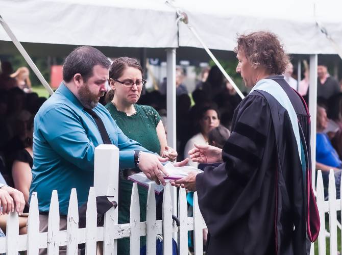 Jim and Crystal Carleton accept a diploma for their son, Wyatt, by Superintendent Randy Wormald on Saturday. Wyatt died in a car accident in January.