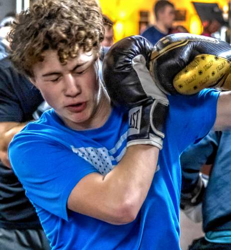 Ritchie Philbrick fends off his brother Ronnie’s punch attempts during their boxing class at Averill's Boxing in downtown Concord on March 7, 2024. They never land an actual punch during the class.