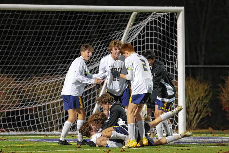Bow High players celebrate the program’s first Division II boys’ soccer championship after beating Lebanon, 2-1, in Nashua on Friday.