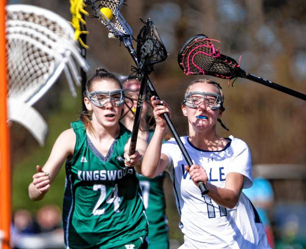 Merrimack Valley midfielder Kaiya Mercier (right) gets ready to score in the second quarter as Kingswood attacker Ava Waldron tries to keep up during the Pride’s 14-3 D-II girls’ lacrosse win on Monday.