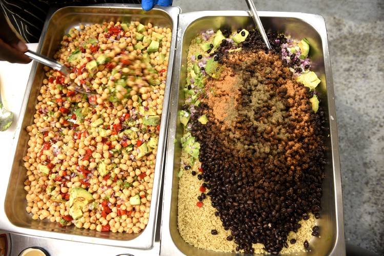  Bowen prepares a quinoa salad and chickpea salad at his new restaurant in West Lebanon.