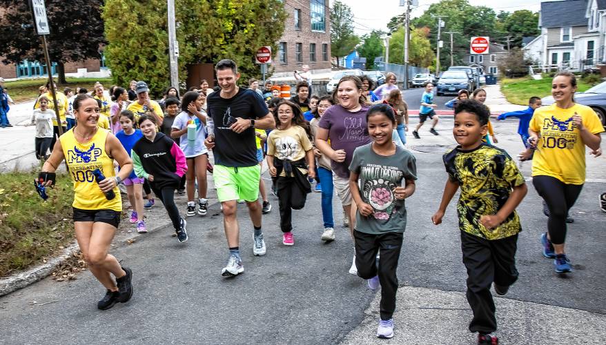Matty Gregg runs with the school children from Mount Pleasant School in Nashua on Thursday morning, October 3, 2024. Gregg is running the length of New Hampshire for child hunger.