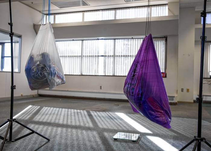 Both the purple trash bag and the store bought bag did withstand the 20-pound test hanging from a crossbar. The purple bag string did stretch a bit longer than the store bought bag.
